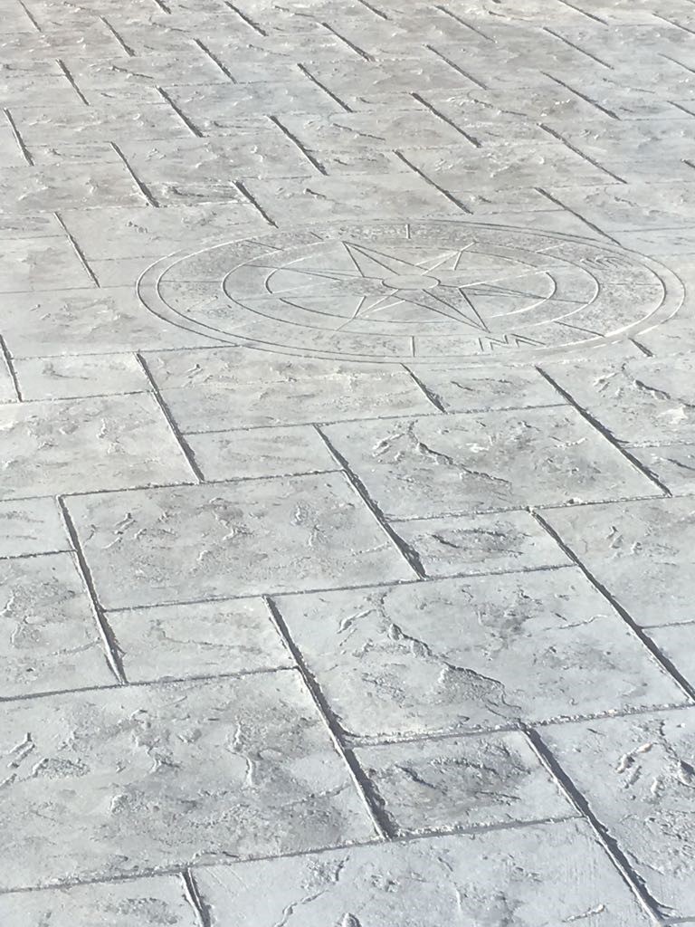 Pattern imprinted concrete driveway- with compass imprint,