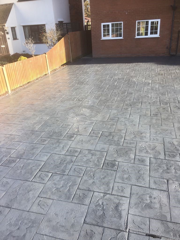 Pattern imprinted concrete driveway- with compass imprint..